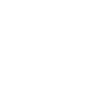 Dentist examining patient's teeth in modern clinical setting with dental equipment visible.
