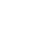 Dentist in white coat examining patient's teeth in modern clinical treatment room.